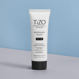 TIZO tube beside 1.75 oz label for size comparison and travel-friendly benefit