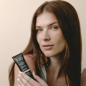 TIZO applying tinted moisturizing serum on face delivering even coverage benefit
