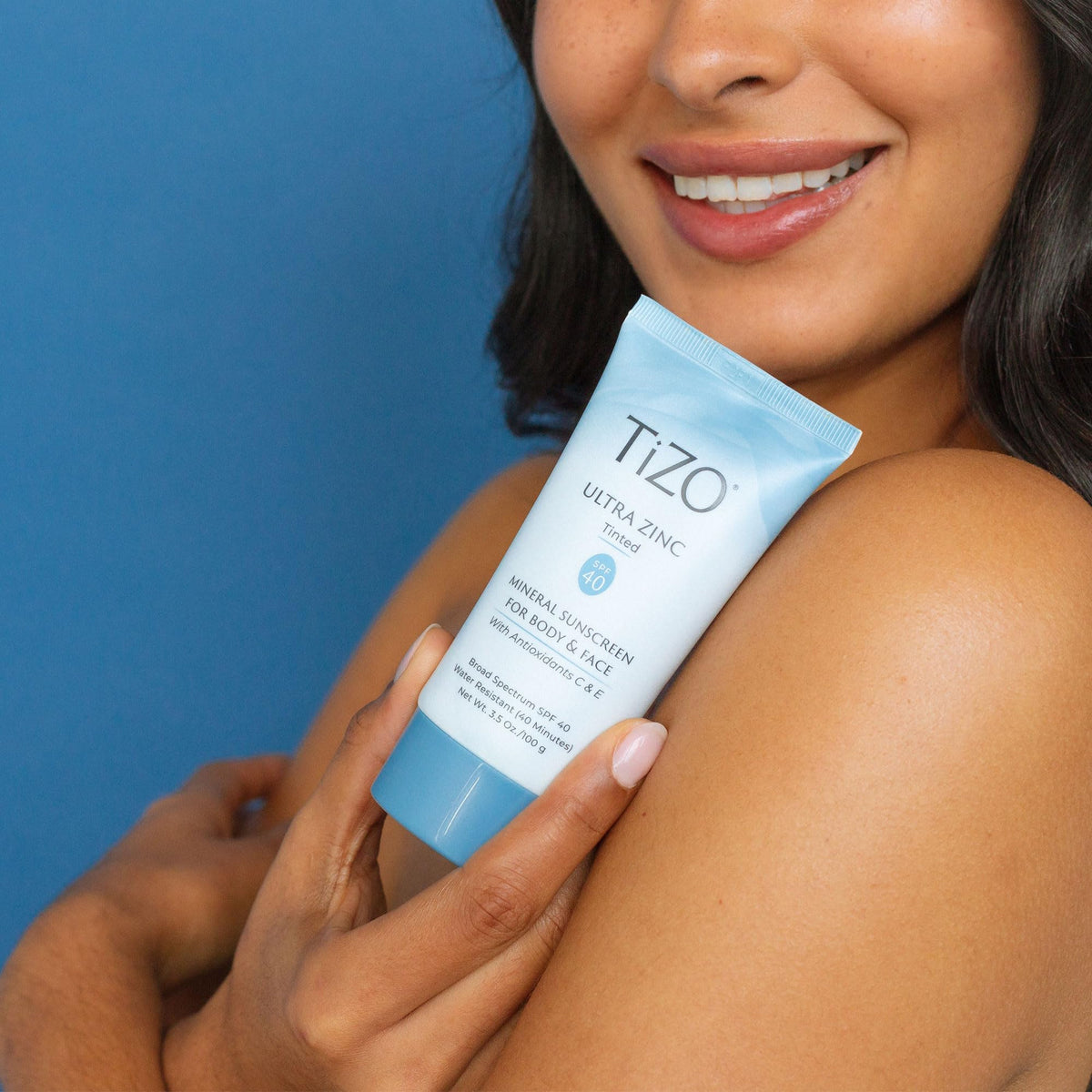 TIZO lifestyle image outdoors showing protected, dewy skin