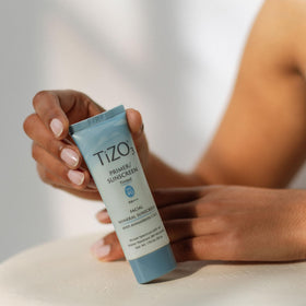 TIZO TiZO3 beside common items showing 1.75 oz size portability