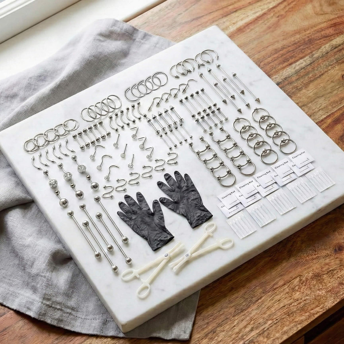 TKKUY needles and jewelry spread showing gauge variety and quick selection