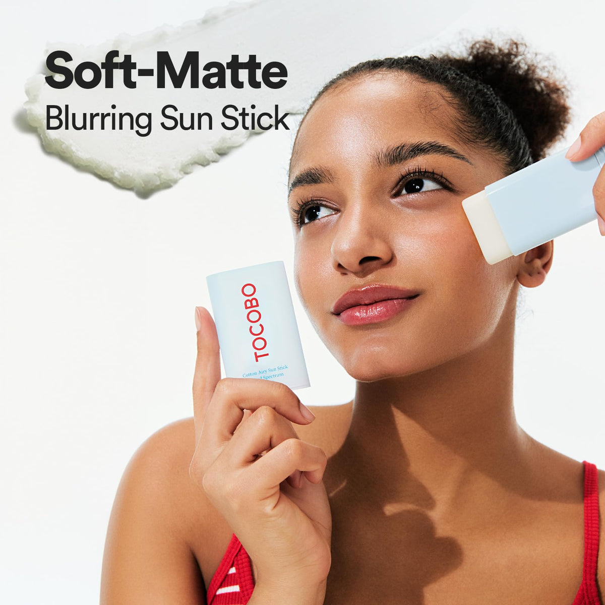 TOCOBO applying sun stick to cheek for quick touch-up benefit