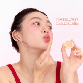 TONYMOLY peach lip balm in hand illustrating compact size and easy portability