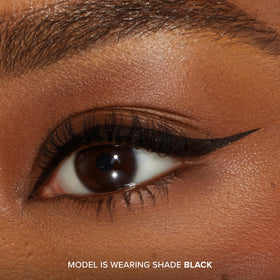 Too Faced in-use photo of model applying winged liner for sharp definition