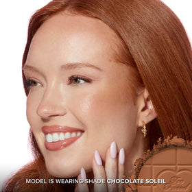 Too Faced travel size in hand illustrating compactness and on-the-go convenience benefit