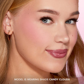 Too Faced brush picking up powder demonstrating easy application and soft-focus result