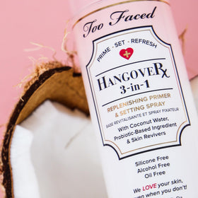 Too Faced spray in use on model to refresh makeup and add glow benefit