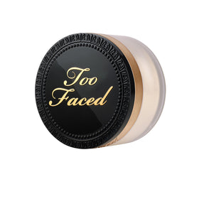 Too Faced powder in lifestyle flatlay with cosmetics, ideal for touch-ups