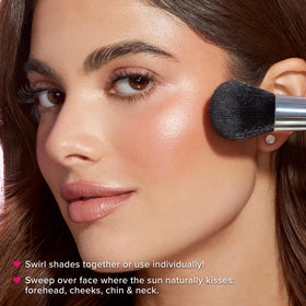 Model wearing Too Faced Sun Bunny on cheeks for natural luminous glow benefit