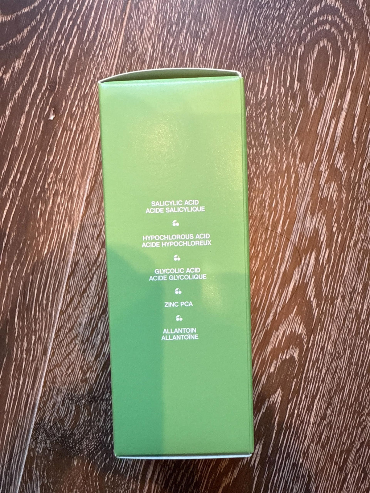 Topicals bottle held in hand for size comparison showing portable 4 fl oz convenience