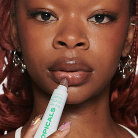 Topicals product with natural ingredient laydown highlighting plant-derived moisturizers benefit