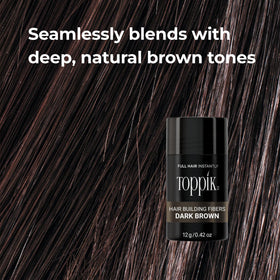 Toppik 12g held in hand showing compact travel-friendly size and convenience benefit