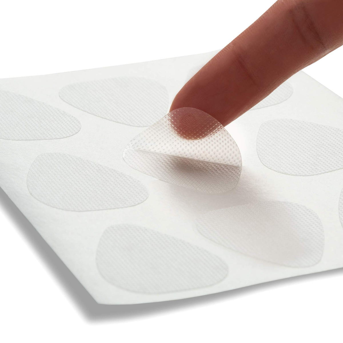 Hand holding patch to show scale of Toute Nuit triangle patches for placement