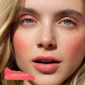 Tower 28 on lips close shot showing glossy coral tint benefit: hydrating lip color
