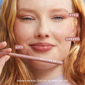 Tower 28 OneLiner texture swipe showing creamy pigment and hydrating finish benefit