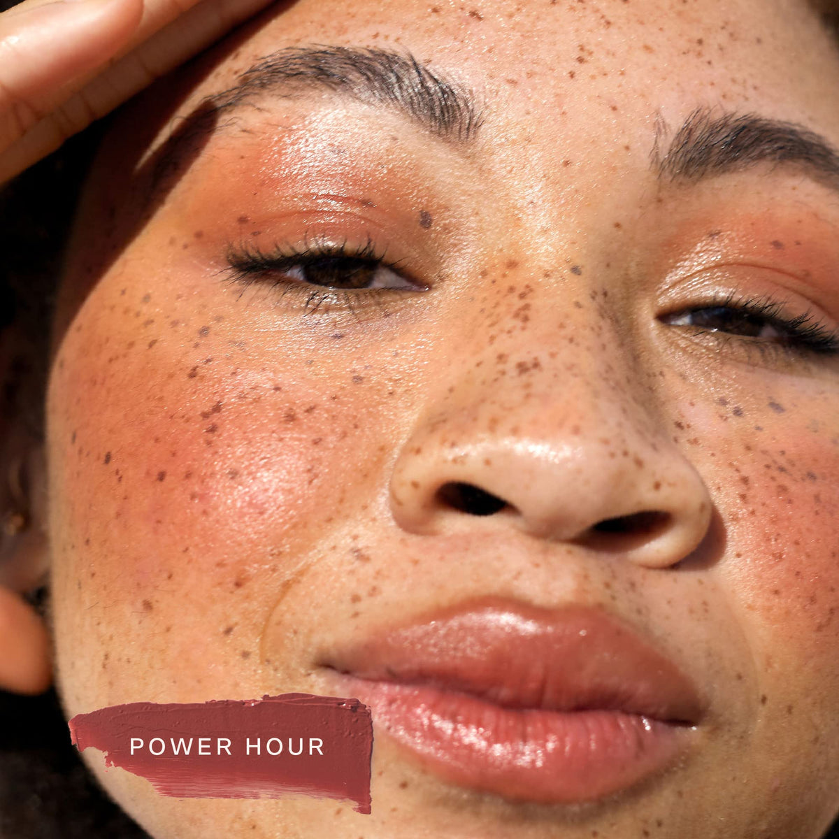 Tower 28 lip application closeup showing juicy tint and hydrating appearance