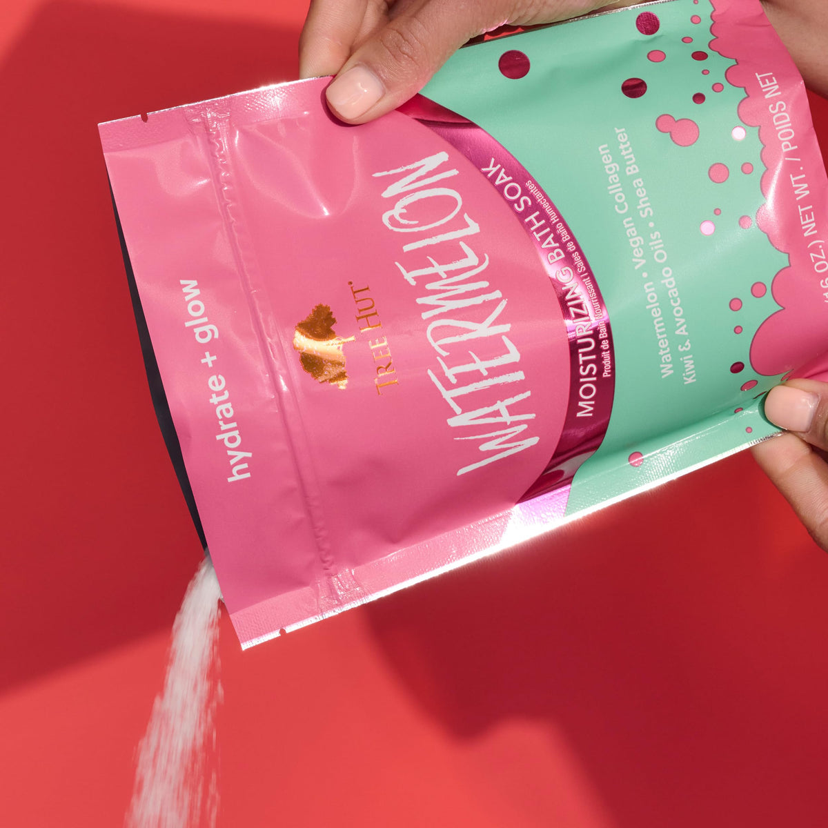 Tree Hut texture close-up of moist pink bath salts illustrating skin-softening