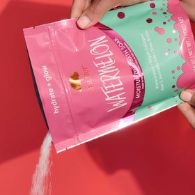 Tree Hut texture close-up of moist pink bath salts illustrating skin-softening