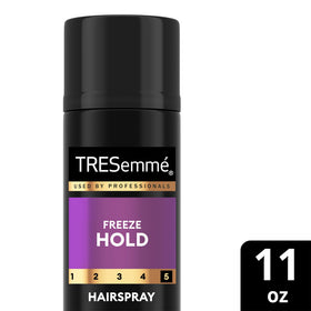 TRESemmé product beside hand for size comparison and portability