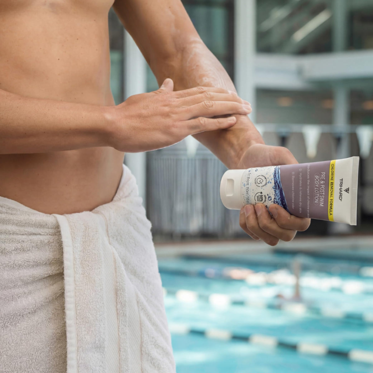 TRIHARD bottle in swim bag lifestyle scene emphasizing poolside protection benefit
