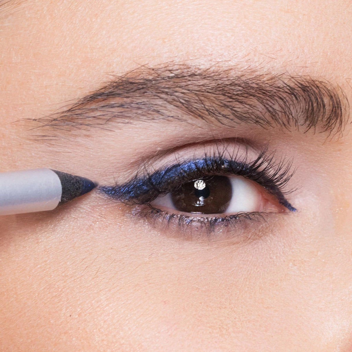 Trish McEvoy eyeliner beside a ruler to show compact 1.2 g size