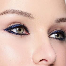 Trish McEvoy eyeliner resisting water droplets illustrating waterproof hold