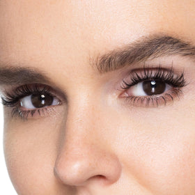 Trish McEvoy mascara being applied in a lifestyle setting for long-wear look