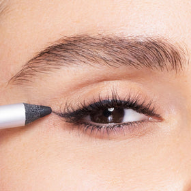 Trish McEvoy gel liner beside coin showing compact 1.2 g travel-friendly size