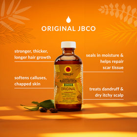 Tropic Isle Living oil drop from open cap showing rich texture and nourishment