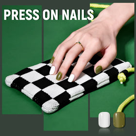 TsMADDTs hand applying a press-on nail with tweezers demonstrating easy at-home application benefit