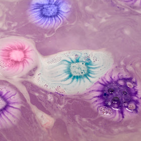 Tub Works mini bath bombs fizzing and foaming in tub for colorful sensory fun