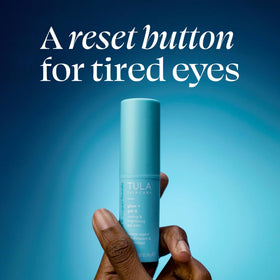 TULA eye balm next to coin to show the portable 0.35 oz size