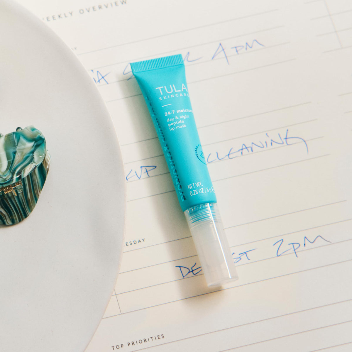 TULA lip mask with ingredient bottles emphasizing peptides and hyaluronic boost