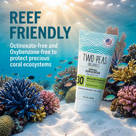 Two Peas Organics family applying sunscreen on beach showing reef-safe outdoor benefit