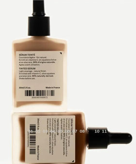 Typology tinted serum applied with brush on hand demonstrating blendability and natural finish