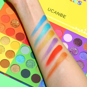 UCANBE palette held in hand for scale showing portable size for travel