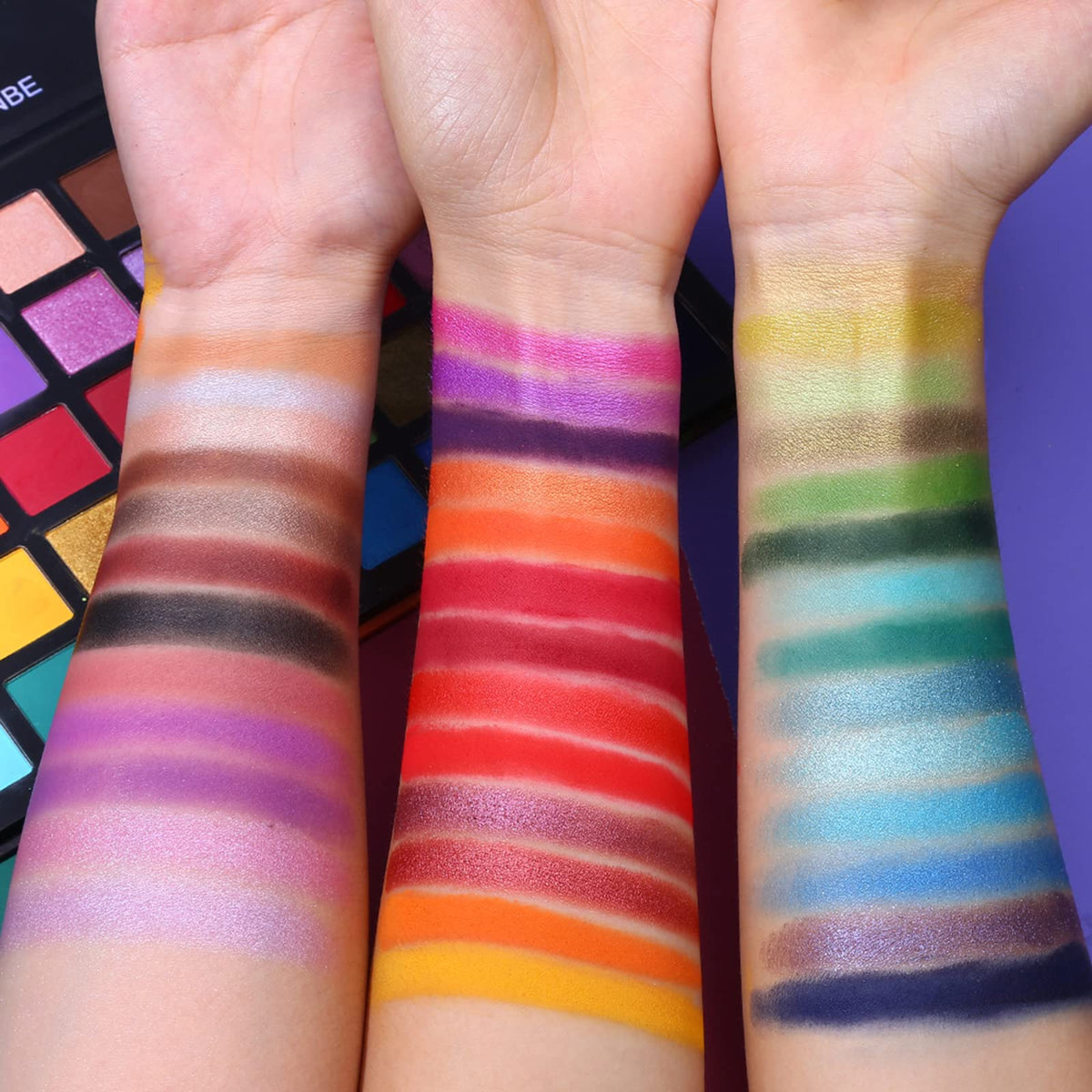 UCANBE Spotlight lid swatches across arm demonstrating vivid pigment and range