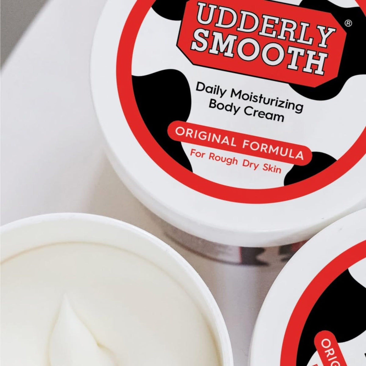 Udderly Smooth hand application demonstrating quick absorption and non-greasy finish
