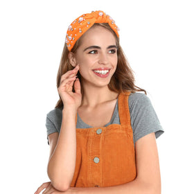 Uintoon headband beside a ruler for size comparison showing compact, wearable scale