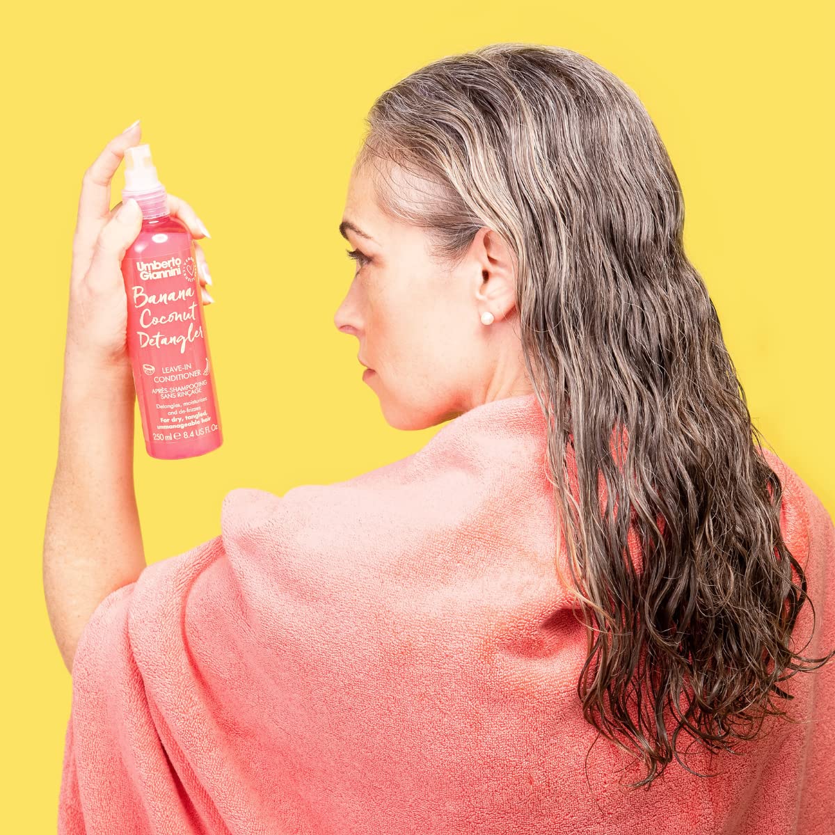 Umberto Giannini bottle in a beach bag for on-the-go hair refreshment