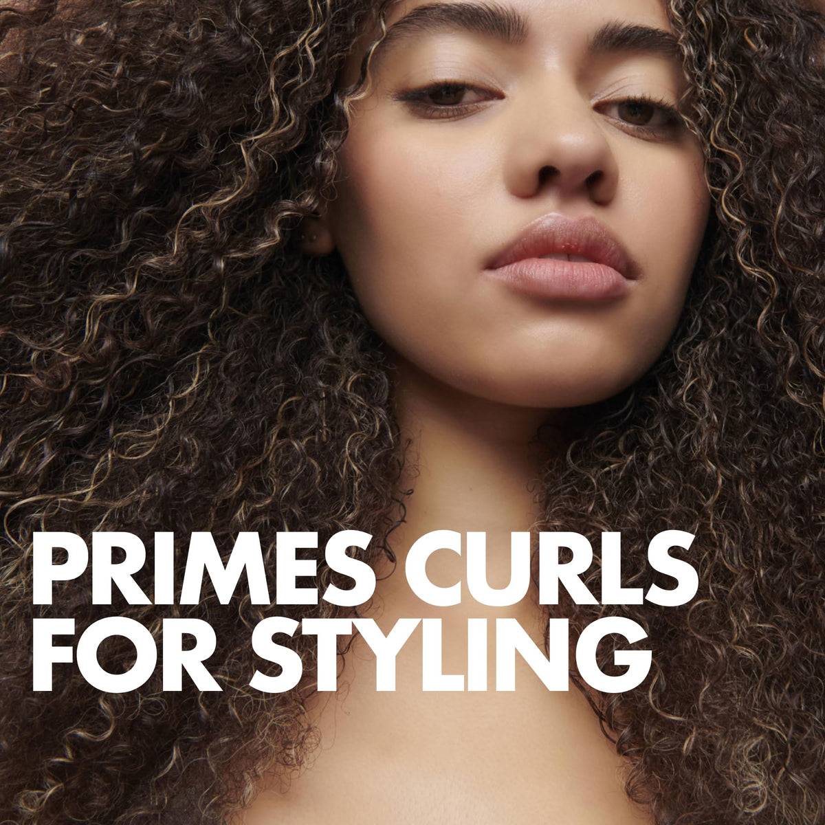 Umberto Giannini being applied to damp hair to enhance curl definition and reduce frizz
