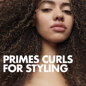 Umberto Giannini being applied to damp hair to enhance curl definition and reduce frizz