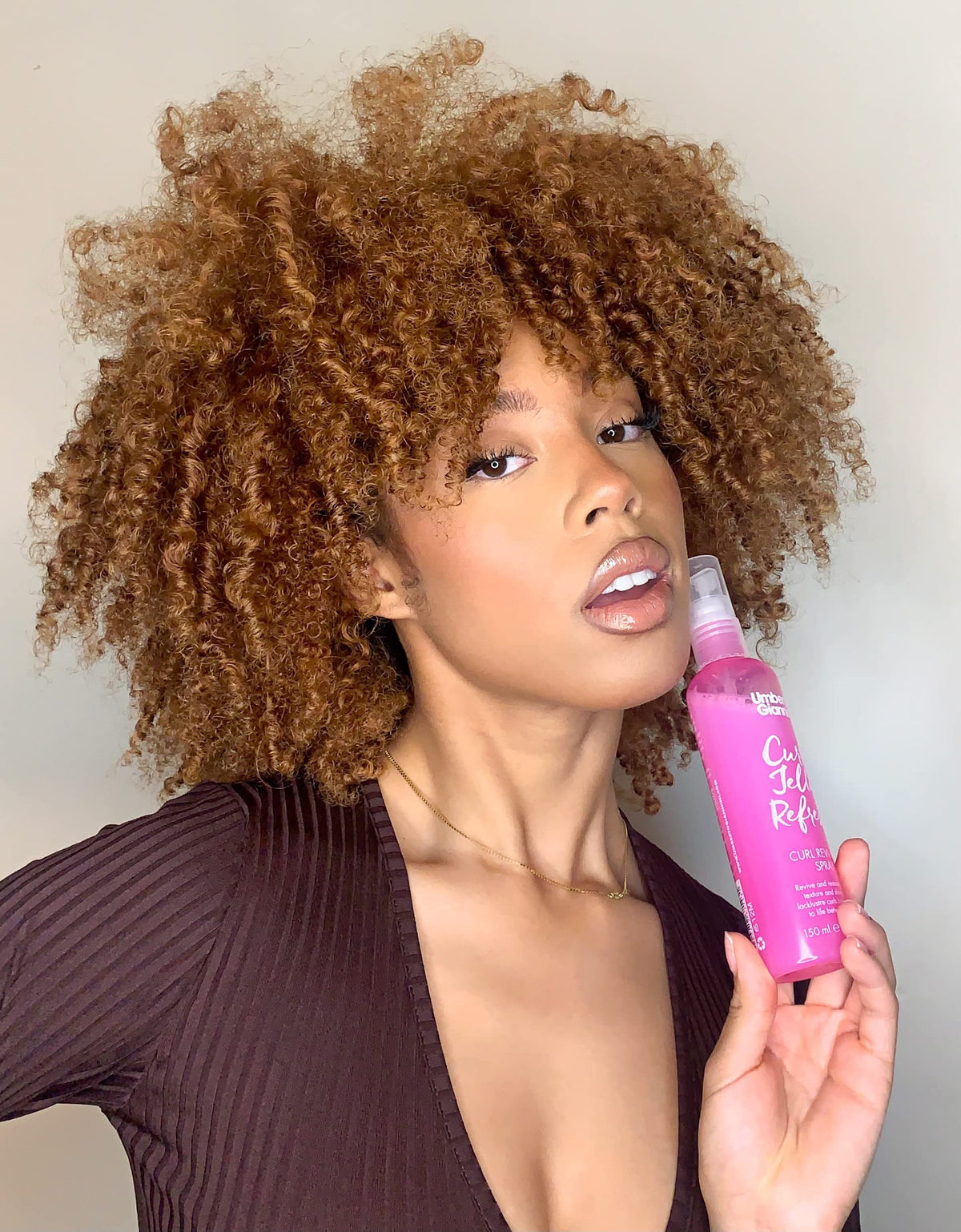 Using Umberto Giannini Curl Jelly to scrunch damp hair for enhanced curl definition