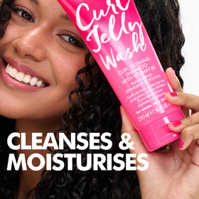 Umberto Giannini applied to model curls demonstrating revived bounce and reduced frizz