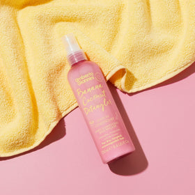 Umberto Giannini held in hand to show 8.4 fl oz scale and portability