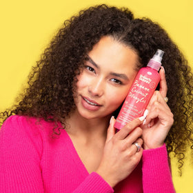Umberto Giannini spray mist being applied for effortless detangling