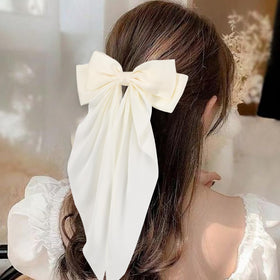Unbednigt oversized bow clipped to ponytail adding instant volume and polish