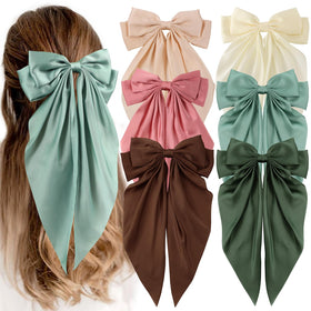 Unbednigt front view of six green oversized satin bows showing set value and gift appeal