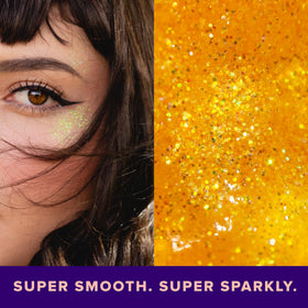 UNICORN SNOT glitter on model cheekbone showcasing reflective orange highlight benefit