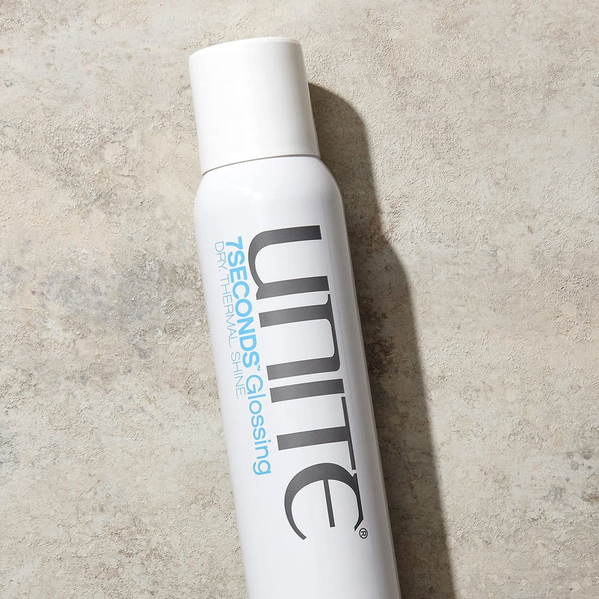 UNITE 7SECONDS close-up fine mist texture demonstrating weightless shine delivery